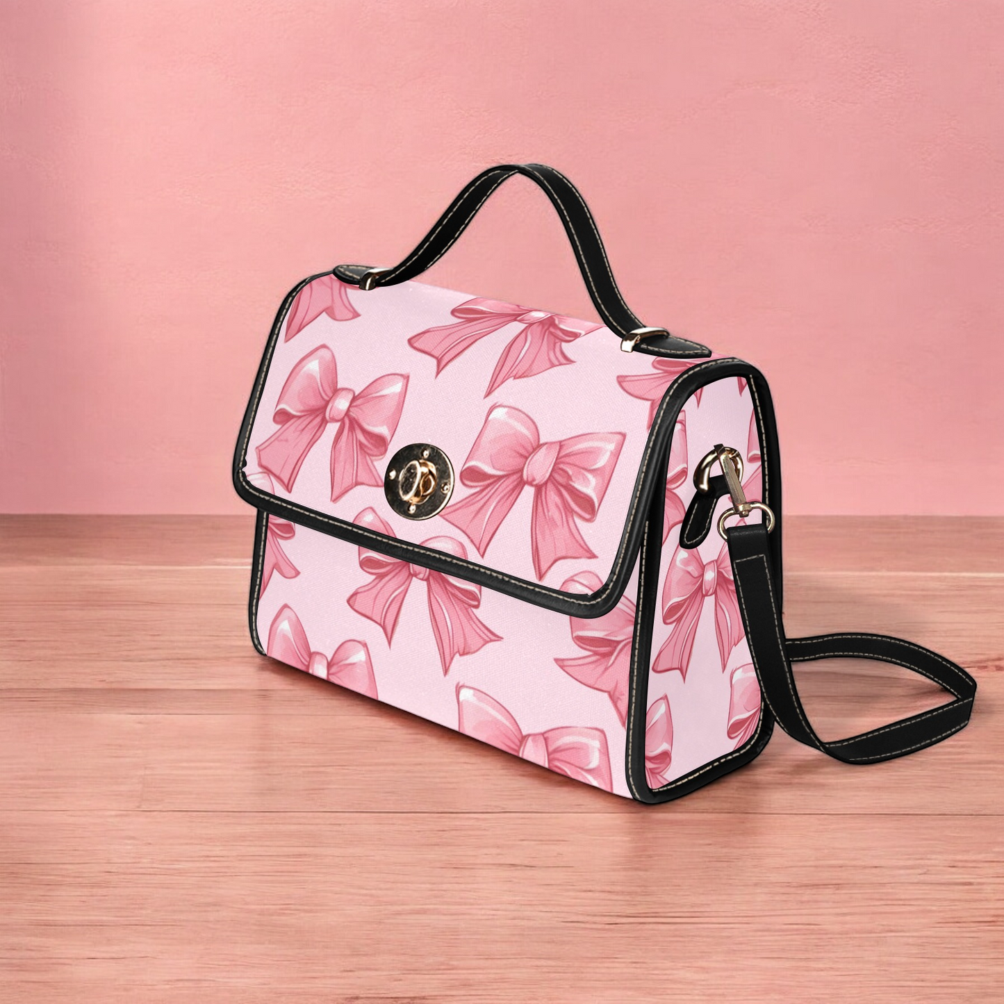 a pink and black handbag with bows on it