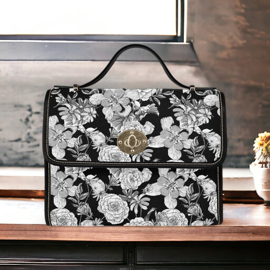 a black and white floral purse sitting on top of a table